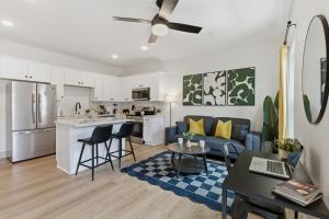 a living room and kitchen with a couch and a table at The Lofts On Maney – Boutique Loft in Downtown Murfreesboro in Murfreesboro