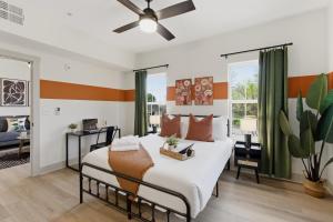 a bedroom with a bed and a ceiling fan at The Lofts On Maney – Boutique Loft in Downtown Murfreesboro in Murfreesboro