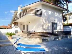 a house with a balcony and two blue slides at Thalassa Holiday Home with Terrace near the Sea - Anzio in Anzio