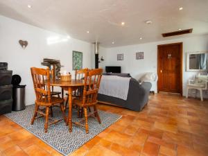 a bedroom with a bed and a table and chairs at 1 Bed in New Moat oc-77692 in New Moat