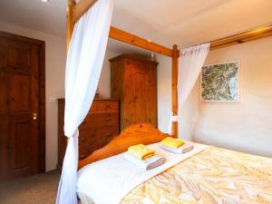 a bedroom with a canopy bed with two pillows at 1 Bed in New Moat oc-77692 in New Moat