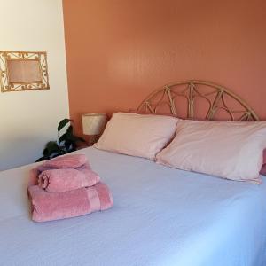 a bedroom with a bed with two towels on it at Cozy Homestay in Rothesay