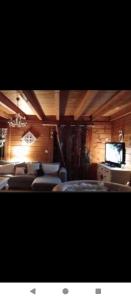 a room with chairs and a flat screen tv at studio in Puessans