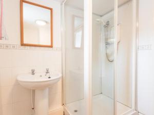 a white bathroom with a sink and a shower at 8 Bed in Cumbria oc-sz373 in Applethwaite +17 photos