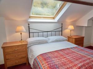 a bedroom with a bed and two night stands with lamps at 8 Bed in Cumbria oc-sz373 in Applethwaite