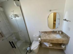 a bathroom with a toilet and a sink and a mirror at Pouso Alvorada in Tiradentes +10 photos