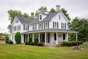 a large white house with a large yard at Jellystone Park Gardiner in Gardiner