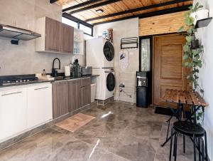 a kitchen with white cabinets and a stove top oven at Casa Surf & Ola in San Felipe de Puerto Plata