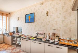 a kitchen with a counter full of food on it at Villa Anna in Darłowo