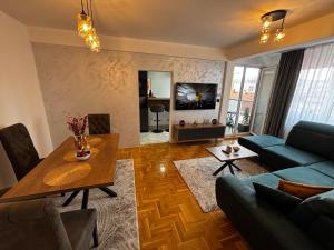 a living room with a couch and a table at Delux apartments in Gornji Milanovac