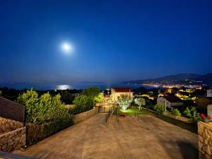 a view from the roof of a house at night at Apartments Alba Chiara in Kastav