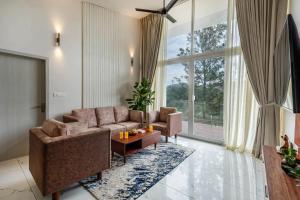 a living room with a couch and a table at Vaga Valley in Vagamon