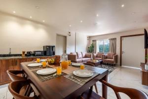a kitchen and living room with a table and chairs at Vaga Valley in Vagamon