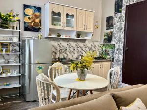a kitchen and dining room with a table and a refrigerator at Getaway Nook in Dedoplis Tskaro
