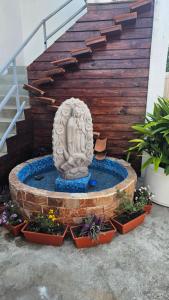 a statue of a woman sitting in a fountain at Suite El Ángel #7 in Tuxtla Gutiérrez