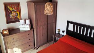 a bedroom with a bed and a dresser and a cabinet at Maison Morgana in Formia