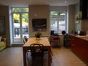 a kitchen and living room with a table and chairs at Gîte d'artiste in Sainte-Marie-aux-Mines +8 photos