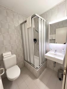 a bathroom with a shower and a toilet and a sink at Dock and Dwell City Appartment in Bern +45 photos