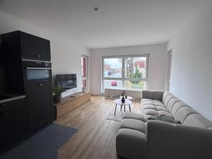 a living room with a couch and a table at Stadttor Quartier Puschkinstrasse 58, Lutherstadt Wittenberg in Lutherstadt Wittenberg