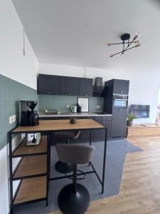 a kitchen with a wooden table and a chair at Stadttor Quartier Puschkinstrasse 58, Lutherstadt Wittenberg in Lutherstadt Wittenberg