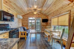 a kitchen and living room of a log cabin at Jellystone Park Gardiner in Gardiner