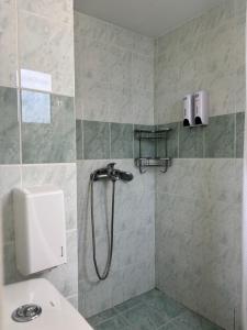 a bathroom with a shower with a toilet and a sink at Sea View Residence in Nea Kios