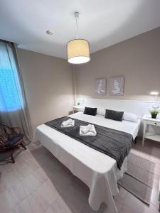 a bedroom with a large bed with a black blanket at Ocean Corner Dúplex Empul in Los Caños de Meca +13 photos