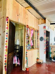a barn with wooden walls and a room with a door at Casa 74 hostel in Comitán