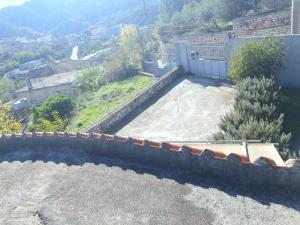 a view of a roof of a house with a yard at Cozy Home in Delvinë +1 photo
