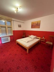 a bedroom with a bed and a chair in it at Holiday house Mernye in Mernye