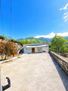 a large parking lot in front of a building at Cozy Home in Delvinë