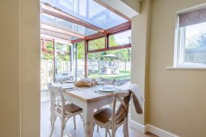a dining room with a white table and chairs at 2 Bed in Hanworth oc-h32041 in Hanworth