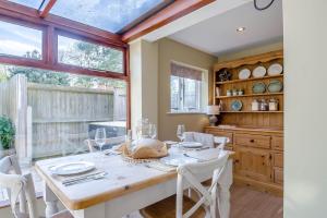 a dining room with a white table and chairs at 2 Bed in Hanworth oc-h32041 in Hanworth +14 photos
