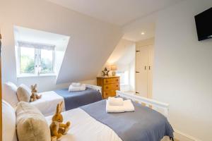 a bedroom with two beds with teddy bears on them at 2 Bed in Hanworth oc-h32041 in Hanworth