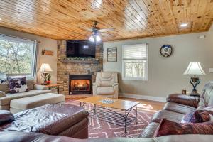 a living room with a couch and a fireplace at Luxe Helen Gem w/Hot Tub + Pool Access in Helen
