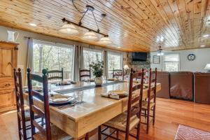 a kitchen and dining room with a large wooden table and chairs at Luxe Helen Gem w/Hot Tub + Pool Access in Helen