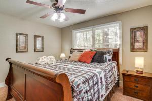 a bedroom with a bed with a ceiling fan at Luxe Helen Gem w/Hot Tub + Pool Access in Helen