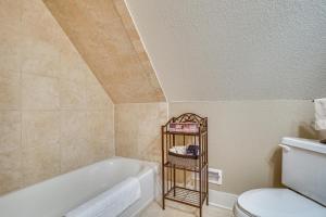 a bathroom with a tub and a toilet at Luxe Helen Gem w/Hot Tub + Pool Access in Helen +35 photos