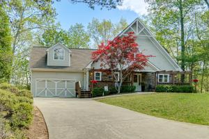 a house with a garage and a driveway at Luxe Helen Gem w/Hot Tub + Pool Access in Helen