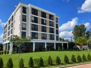 an office building with a lawn in front of it at Hotel Magnific in Kranevo +27 photos