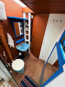 a bathroom with a blue sink and a toilet at Chales Bamboo Jungle in Petrópolis +114 photos