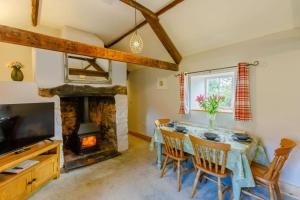 a dining room with a table and a fireplace at 2 Bed in Chulmleigh oc-87668 in Chulmleigh