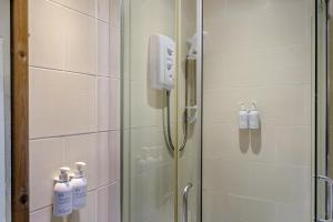 a shower with a glass door with a soap dispenser at 2 Bed in Keswick oc-28377 in Braithwaite +11 photos