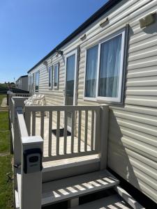 a porch of a mobile home with a fence at 50 Seaview Ingoldmells in Ingoldmells