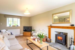 a living room with a couch and a fireplace at 3 Bed in Ripon oc-83728 in Healey
