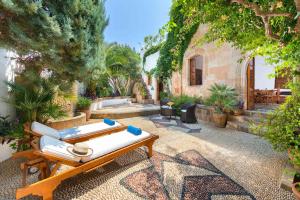 a patio with a table and chairs and trees at Antique Villa in Líndos