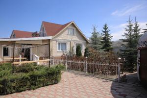 a house with a fence in front of it at Karakol Riviera in Karakol