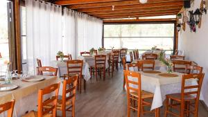 a row of tables and chairs in a restaurant at Agriturismo Azzarone in Vieste