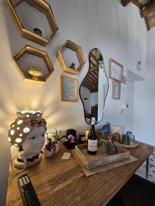 a dressing table with a mirror and a bottle of wine at Borgo del Marchese in Ortona +139 photos