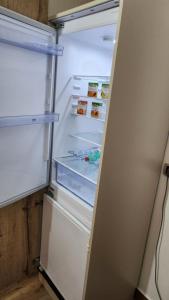 an open refrigerator with its door open and food inside at La Terrazza di Rovaglioso in Palmi